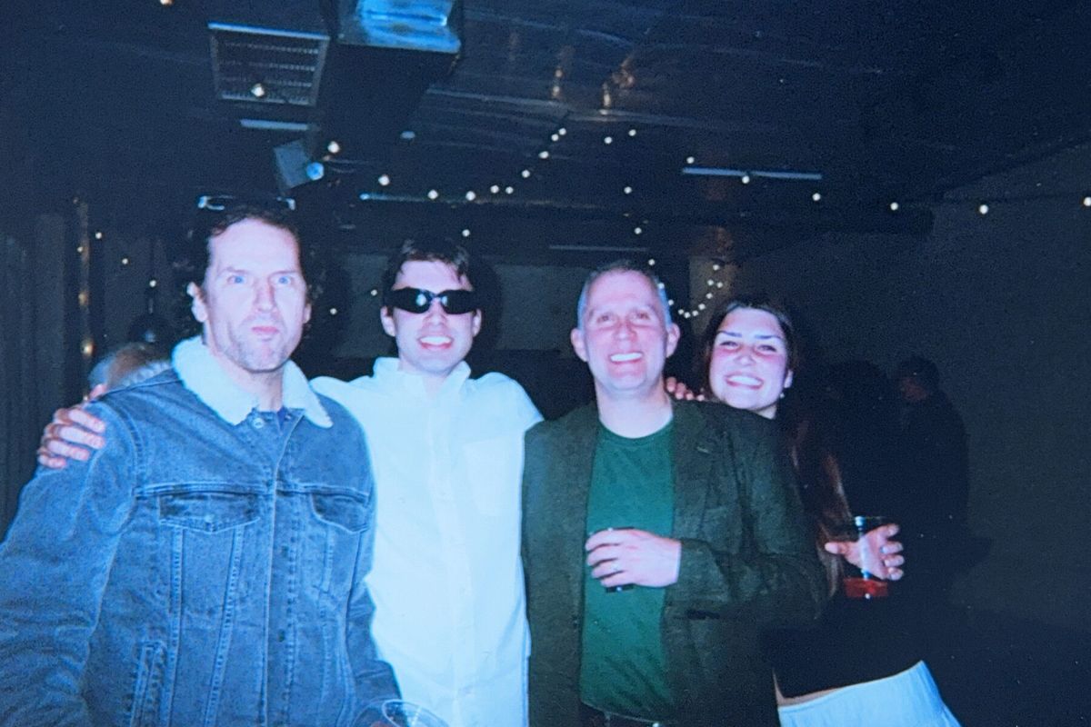 Friends smiling together at a past Winter Solstice party